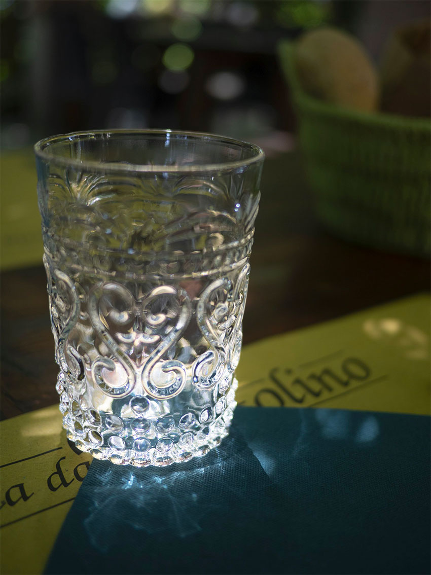 Reflection of a glass on the placemat of Locanda Bortolino Restaurant